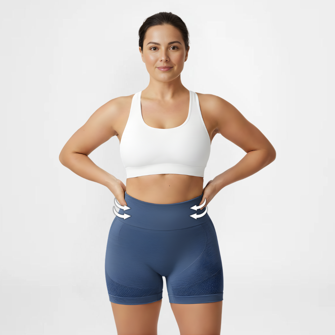 Woman wearing a white sports bra and blue shorts on a light gray background